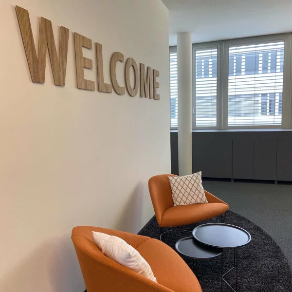 Two orange-coloured armchairs adorn the entrance area of the new office