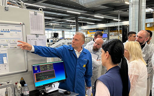 Polycontact AG employee shows guests around the production halls